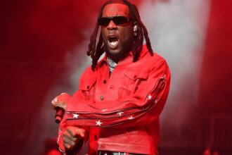 Burna Boy Love, Damini album review editorial style image showing reflective portrait, emotional storytelling theme, and Ladysmith Black Mambazo collaboration moment