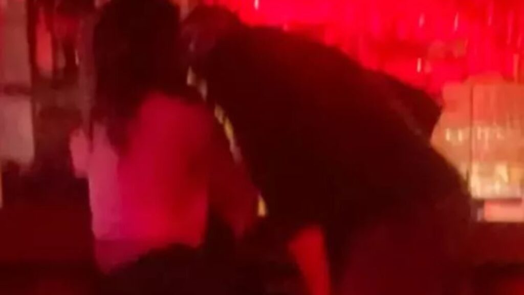 Dianna Russini and Mike Vrabel seen in a dimly lit bar in Manhattan appearing close and affectionate as viral kissing photos circulate online.