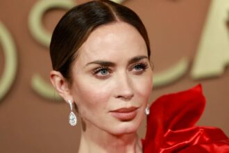 Emily Blunt red carpet French tip manicure with glossy red polish and pearl floral nail art design