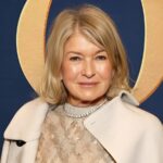Martha Stewart taking a candid mirror selfie with clipped hair, messy bangs, and smudged mascara during a glam session in Milan