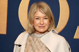 Martha Stewart taking a candid mirror selfie with clipped hair, messy bangs, and smudged mascara during a glam session in Milan