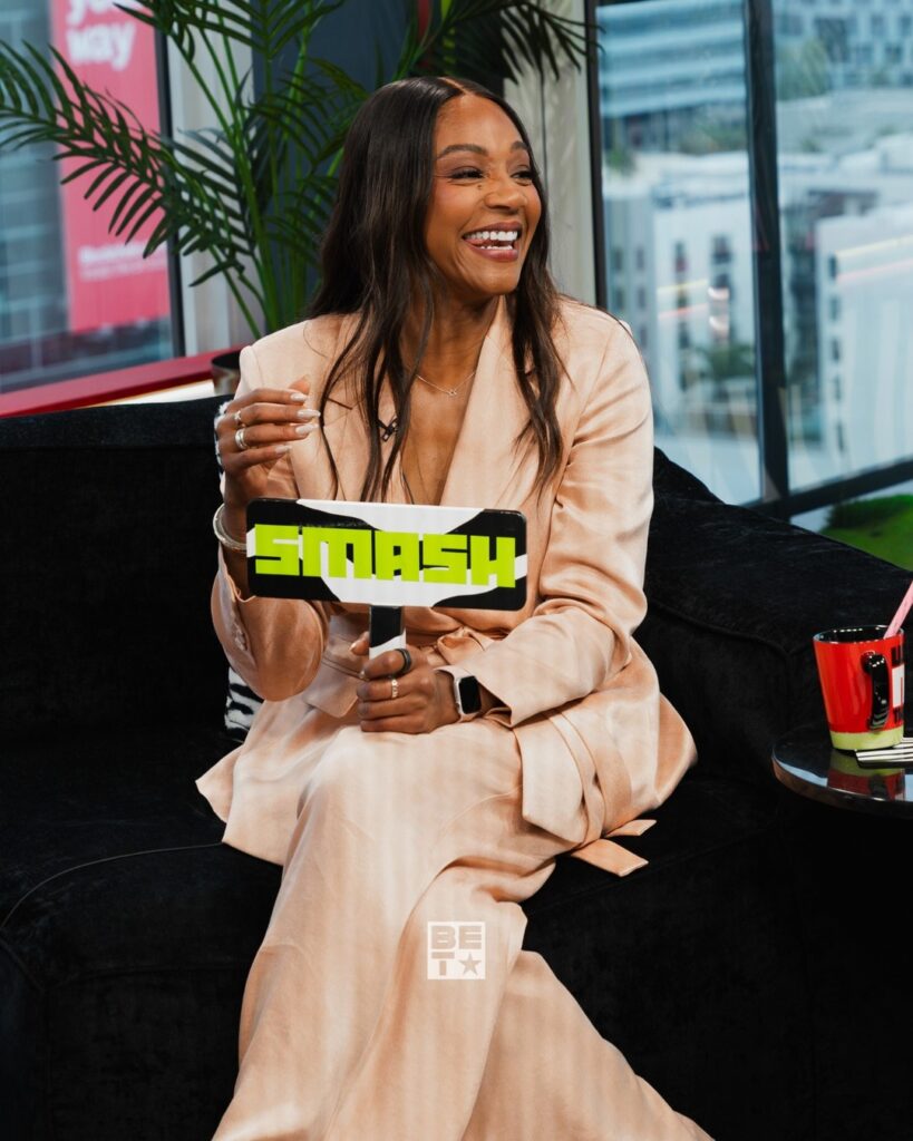 Tiffany Haddish reacting during a TV interview segment where she jokes about Nigerian singer Burna Boy in a viral clip.
