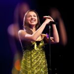 Olivia Rodrigo celebrating UK Number 1 chart success while Justin Bieber and other artists appear in a music chart collage showing Top 40 movement