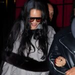 Rihanna leaving César Restaurant in Paris at sunrise wearing a sporty gray checked bomber jacket, Balenciaga leggings, red pumps, and yellow mini handbag