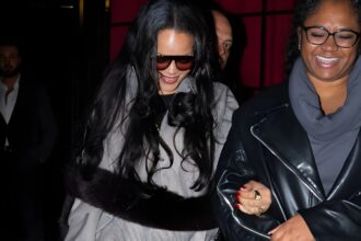 Rihanna leaving César Restaurant in Paris at sunrise wearing a sporty gray checked bomber jacket, Balenciaga leggings, red pumps, and yellow mini handbag