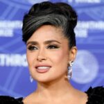 Salma Hayek wearing a sleek updo with visible gray hair at the Breakthrough Prize red carpet event