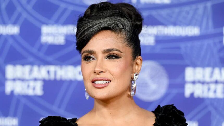 Salma Hayek wearing a sleek updo with visible gray hair at the Breakthrough Prize red carpet event