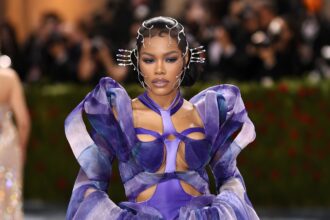 Teyana Taylor wearing bold couture at the Met Gala red carpet with dramatic styling and statement fashion look