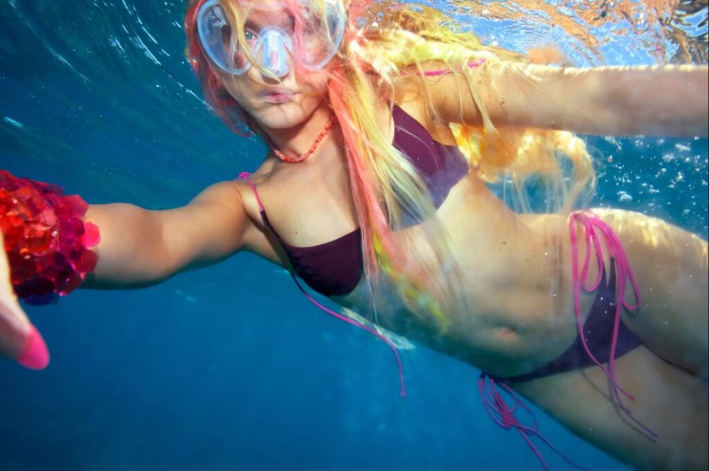 Zara Larsson wearing colorful beachy swimwear from her Main Rose collection in Miami
