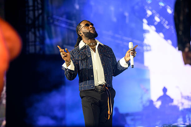 Burna Boy Love, Damini album review editorial style image showing reflective portrait, emotional storytelling theme, and Ladysmith Black Mambazo collaboration moment