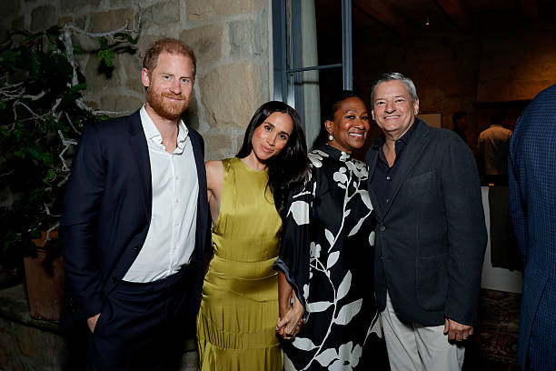 Meghan Markle and Prince Harry with Netflix CEO Ted Sarandos and Nicole Avant posing together at a public event amid ongoing partnership discussions