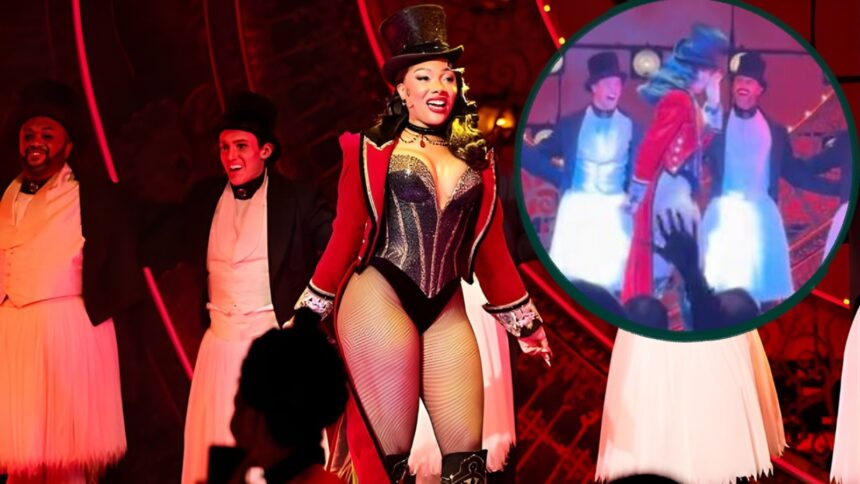 Megan Thee Stallion pausing on stage during a Moulin Rouge Broadway performance, appearing emotional and holding back tears after her breakup news