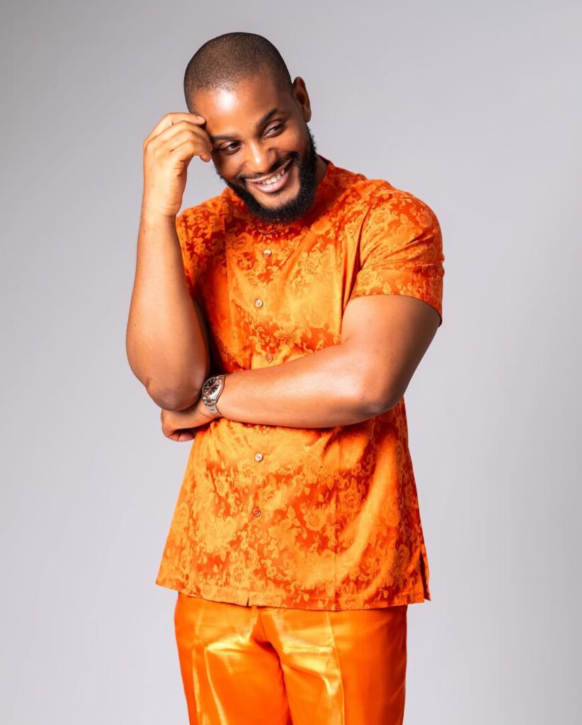 Alex Ekubo smiling during a Nollywood event as Rita Dominic, Mercy Johnson, and other celebrities mourn his reported death online.
