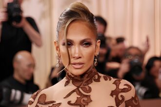 Jennifer Lopez showing off her toned figure and glowing confidence in a stylish fitted outfit during a viral celebrity appearance