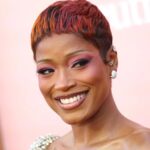 Keke Palmer wearing pink sunset ombré pixie hair with rosy eye makeup at the 2026 Billboard Women in Music Awards
