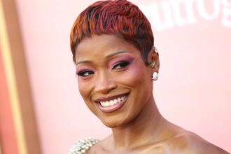 Keke Palmer wearing pink sunset ombré pixie hair with rosy eye makeup at the 2026 Billboard Women in Music Awards