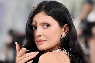 Kylie Jenner wearing a nude Schiaparelli sculptural dress with illusion details at the 2026 Met Gala