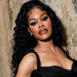 Teyana Taylor with long voluminous curls in a black gown at Valentino event
