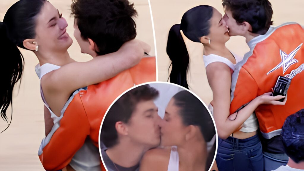 Kylie Jenner and Timothée Chalamet kissing courtside at a New York Knicks game at Madison Square Garden while wearing matching orange jackets and jeans