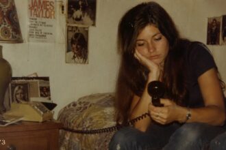 Woman lying on her bed late at night staring at her phone while overthinking mixed signals and modern dating confusion.
