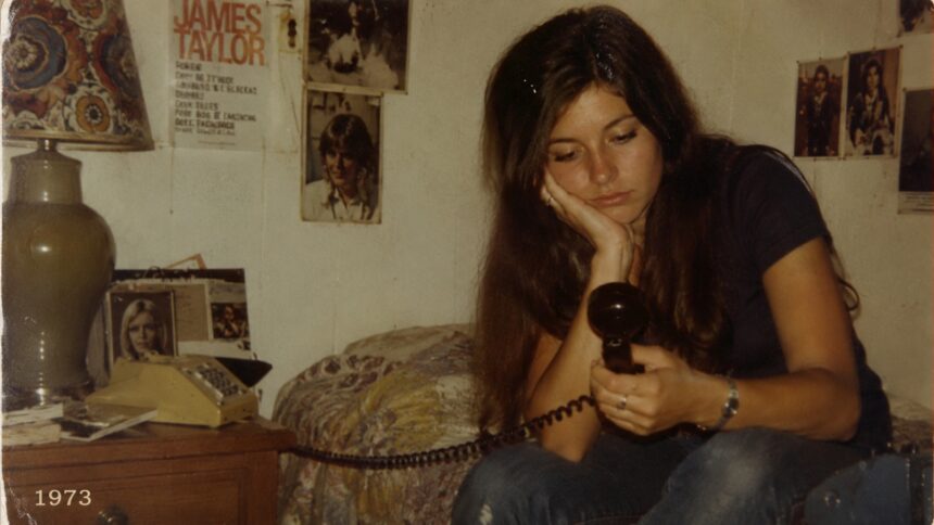 Woman lying on her bed late at night staring at her phone while overthinking mixed signals and modern dating confusion.