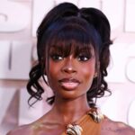 Olandria Carthen wearing a sleek Party Ponytail hairstyle with long bangs and a glamorous sheer dress at the Sports Illustrated Swimsuit launch party in New York City.