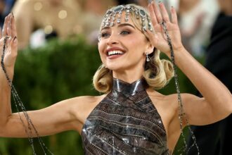 Sabrina Carpenter at the Met Gala 2026 wearing a 1920s-inspired faux bob hairstyle with sculpted curls, sparkling headpiece, and vintage glam makeup