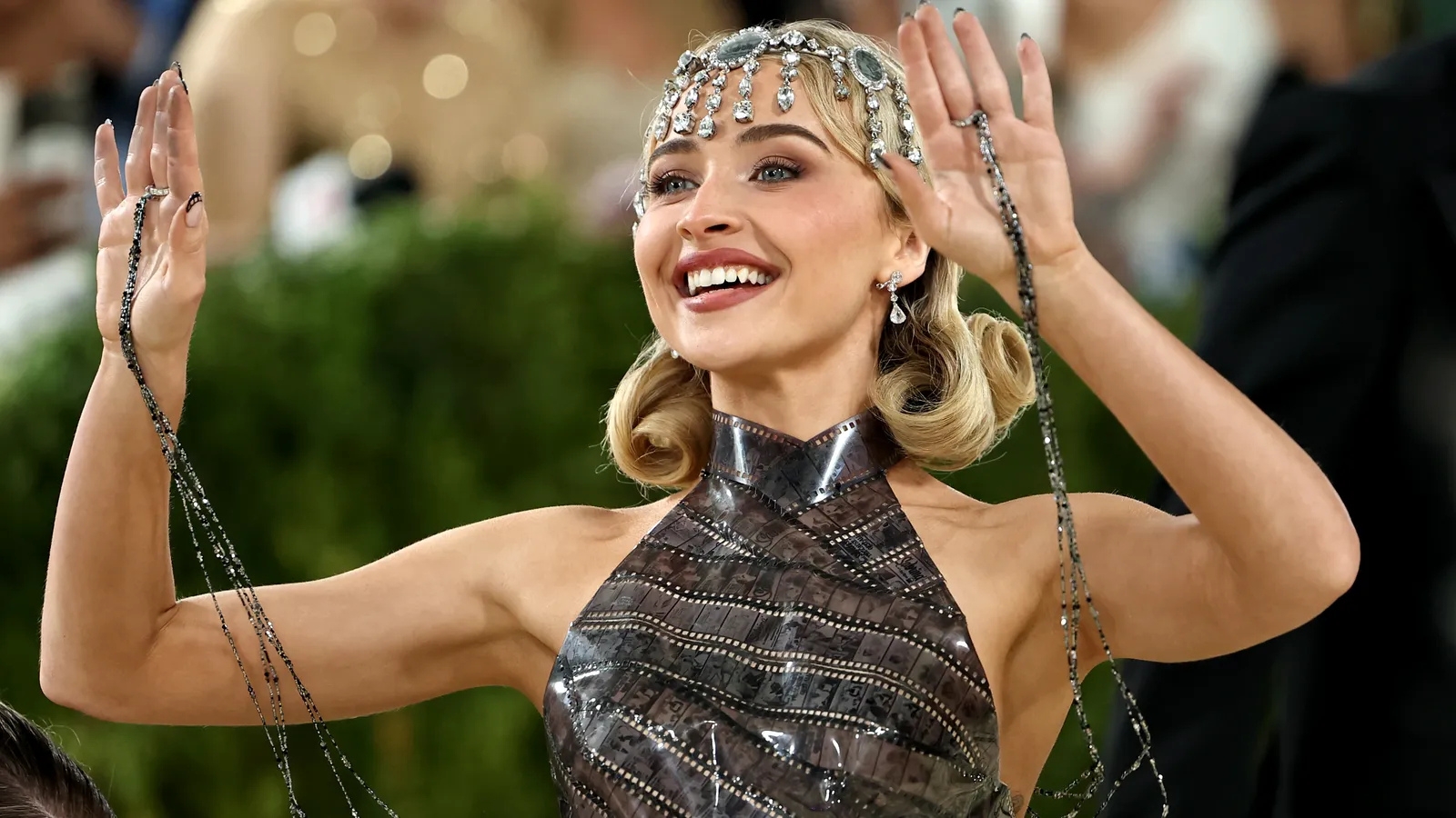 Sabrina Carpenter at the Met Gala 2026 wearing a 1920s-inspired faux bob hairstyle with sculpted curls, sparkling headpiece, and vintage glam makeup