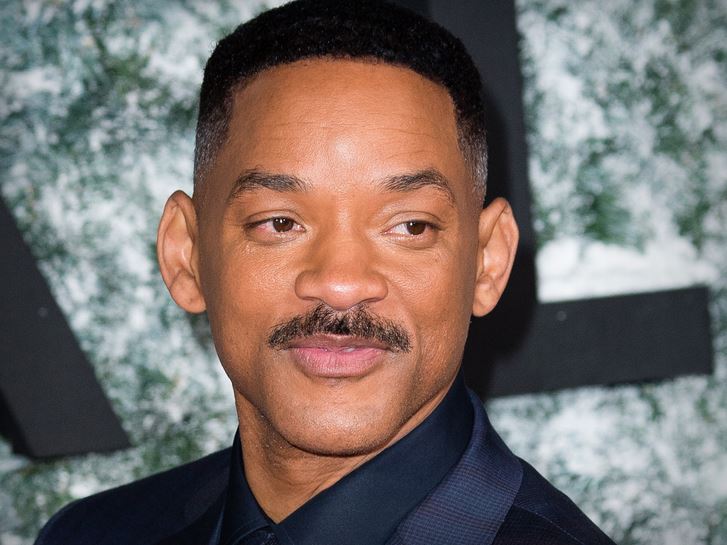 Will Smith reacting during a public appearance after a judge dismissed the sexual harassment lawsuit filed by violinist Brian King Joseph